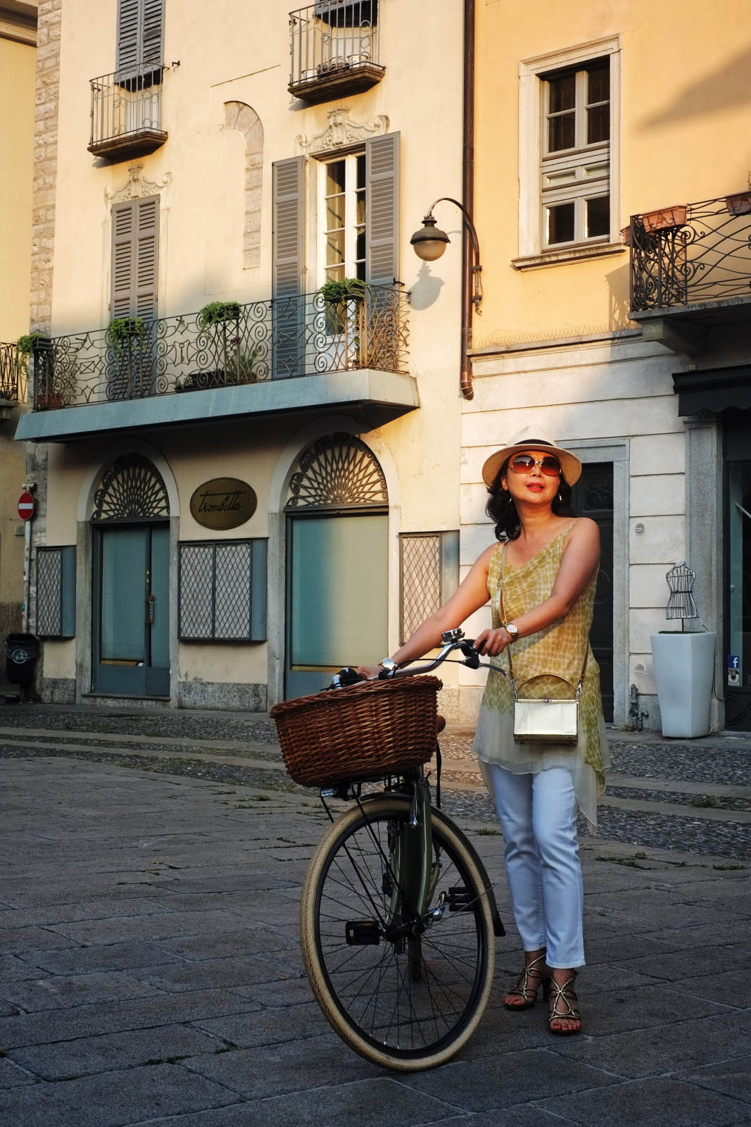 Woman with hotel bicycle in Como, Italy. Hotel and tourism photography by Kent Johnson at Hi-Fidelity 360.